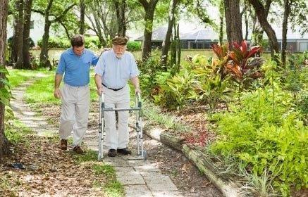 Senior citizen with dementia enjoying a walk outside at a Three Rivers area adult day care