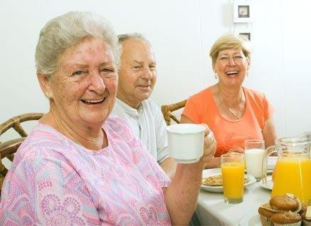 Three seniors enjoying coffee and breakfast at a Three Rivers area senior center in Georgia